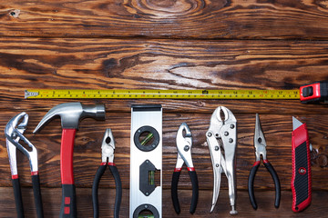 Close up tools on a wooden background.