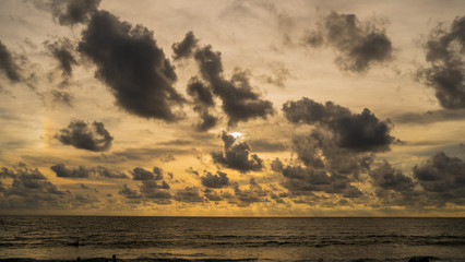 A of the large dark tone sunset as the massive sun sets into the horizon above the ocean, Sunset sky clouds. Sunset sky background. Sunset sky orange blue.at Phuket Thailand.;
