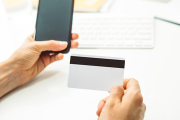 Shopping online with a credit card and smartphone.  Empty blank form.