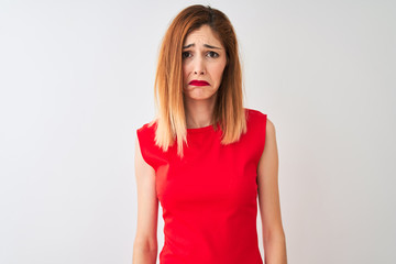 Redhead businesswoman wearing elegant red dress standing over isolated white background depressed and worry for distress, crying angry and afraid. Sad expression.