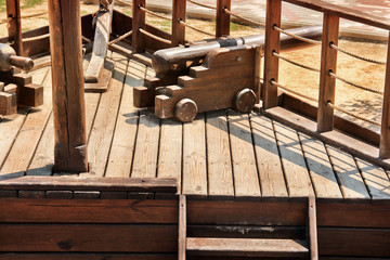 The old ship. Part of a wooden ship. Weapons on a ship.
