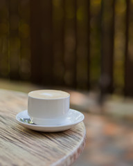 Cup of cappuccino on the table in a outdoor cafe