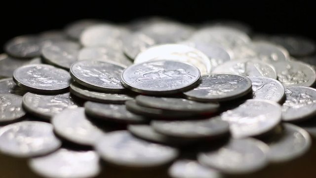 Close Up Of Rotating Lithuanian Aluminum Cent Coins On Black Background.