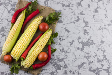 Fototapeta na wymiar Corn and tomatoes with copy space