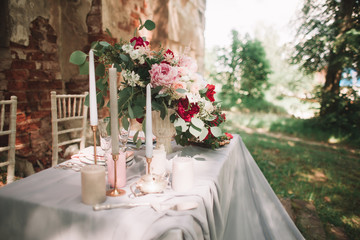 beautiful wedding table with candles in the garden.