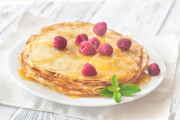 Stack of crepes with raspberries