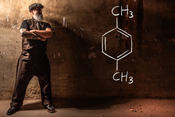 Bearded old man presenting handdrawn chemical formula of Xylene