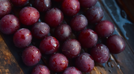 lots of ripe plums on a wooden table