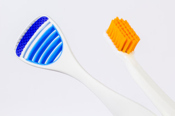 Toothbrush and tongue scraper