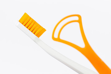 Toothbrush and tongue scraper