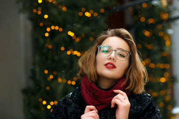 Glamor girl wearing glasses walking at the street
