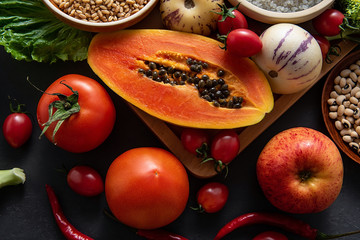 Full screen of fresh seasonal fruits and vegetables and whole grains