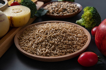 Fresh seasonal fruits and vegetables and buckwheat kernels close-up