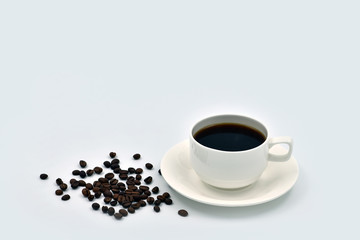 Cup of coffee and grains on a plain white background