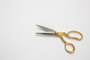 Scissors gold and silver isolated against white background
