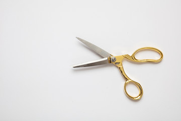 Scissors gold and silver isolated against white background