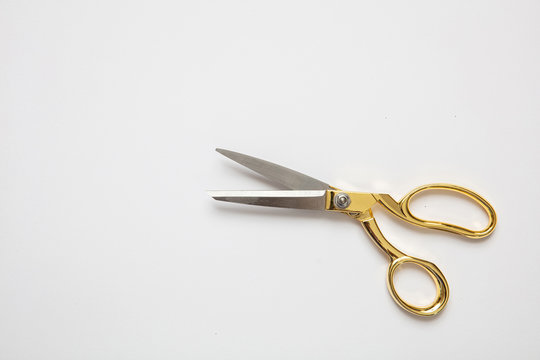 Scissors gold and silver isolated against white background