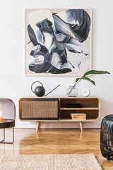 Scandinavian and design home interior of living room with wooden commode, design black lamp, rattan basket, plants and elegant accessories. Stylish home decor. Template. Mock up poster paintings. 
