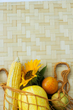Corn pumpkin and sonflower in string bag