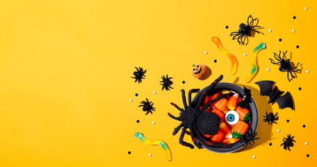 Halloween decorations with witch cauldron - overhead view flat lay