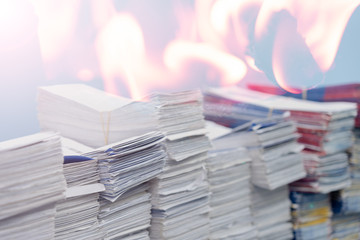 Double exposure, Stacks of paper files or documents and fire.