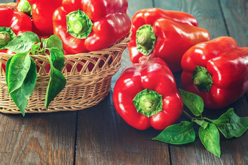 fresh pepper on the table. red sweet pepper close-up. paprika in a wicker basket. background with bell peppers.