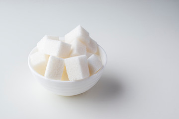 Pile of sugar cubes in sugar bowl