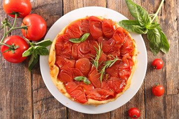 tomato quiche with basil on wood background