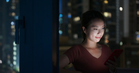 Woman use of smart phone at night
