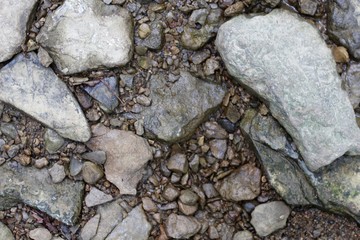 A close view of the rocks and stones in the creek bed.