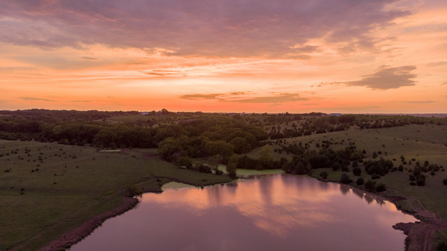 Sunrise over rural Nebraska wetland and stock pond © Phyre Sky