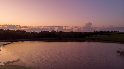 Naklejka premium Sunrise over rural Nebraska wetland and stock pond