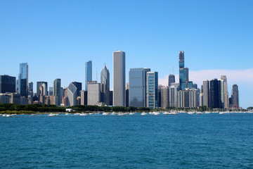 Fototapeta na wymiar Chicago downtown skyline with Michigan lake.Scenic summer cityscape with lakefront skyscrapers of Chicago with drifting yachts on the Michigan lake harbor. American urban city architecture background.