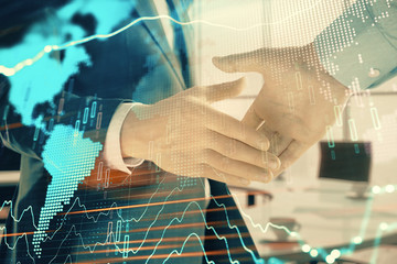 Multi exposure of financial chart and map on office background with two businessmen handshake. Concept of success in business