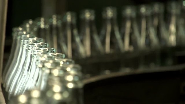 Cola bottle glass. Manufacturing industrial factory.  Empty Transparent Bottles Moving on Conveyor Belt. Technological line production