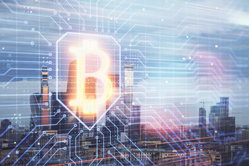 Double exposure of bitcoin sign drawing hologram on cityscape background. Concept of crypto economy