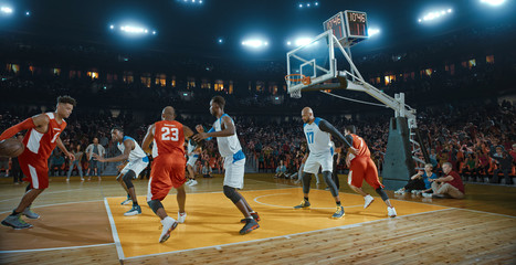 Basketball players on big professional arena during the game. Tense moment of the game. Celebration