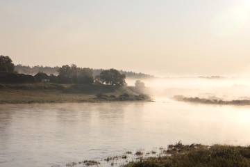 Obraz na płótnie Canvas riverbank on a foggy summer morning