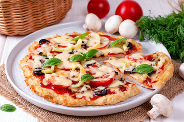 Delicious sliced pizza with chicken, tomatoes and mozzarella
