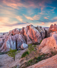 Gorgeous world of Cappadocia. Picturesque spring sunset in Red Rose valley in April. Cavusin village located, district of Avanos in Nevsehir Province in the Cappadocia region of Turkey, Asia.