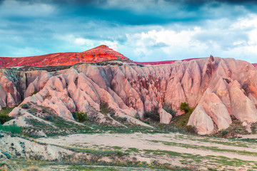 Breathtaking world of Cappadocia. Picturesque spring sunset in Red Rose valley in April. Cavusin...