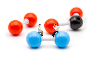 Miniature scientist observing and discussing on molecular structure and bonding of nitrogen carbon...