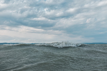 wave crest on the lake Balaton mountains in the background