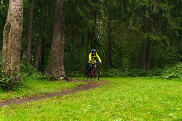 equipped cycling tourist on a trail in the forest
