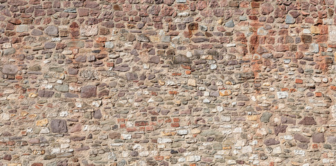 Old middle age fortress wall with pattern of bricks and stones in Germany