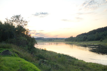 Fototapeta na wymiar Sunset by the river in the summer countryside