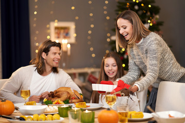 Beautiful family eating Christmas dinner at home