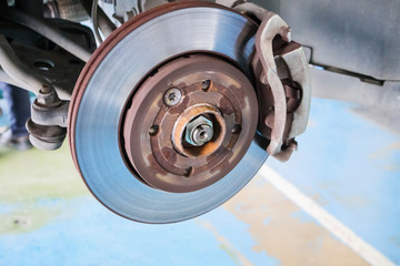 Close up disc brake at car service workshop