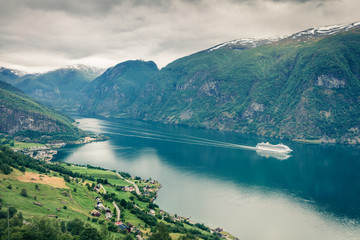 View from the bird eye's of Sognefjorden fjord. Misty morning scene of Aurlandsvangen village, Norway. Traveling concept background. Instagram filter toned..