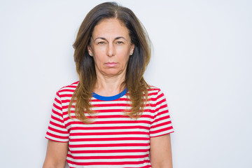 Obraz premium Middle age senior woman standing over white isolated background skeptic and nervous, frowning upset because of problem. Negative person.